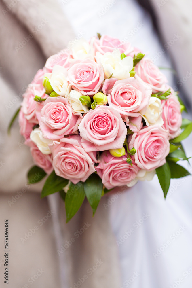 beautiful tender wedding bouquet of roses in hands of the bride
