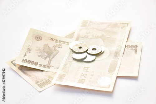 Japanese yen banknote and coin on white background  