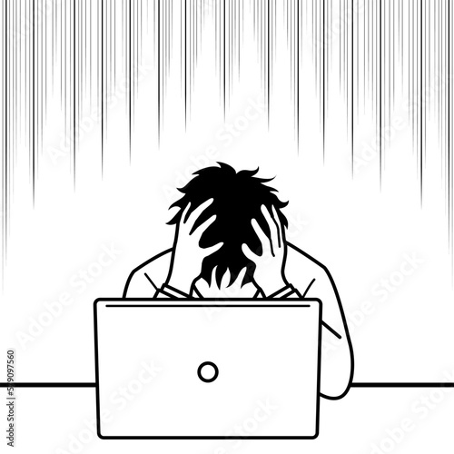パソコンを前に頭を抱え落ち込む男性