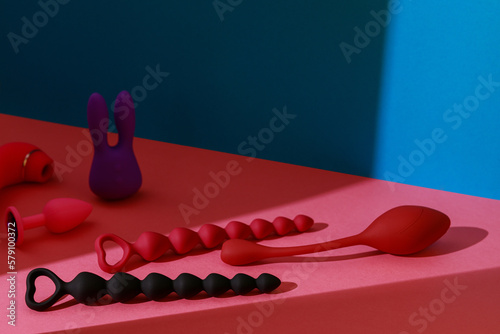 Different adult sex toys such as dildo, vibrator, buttplug on colored background. Sex shop concept