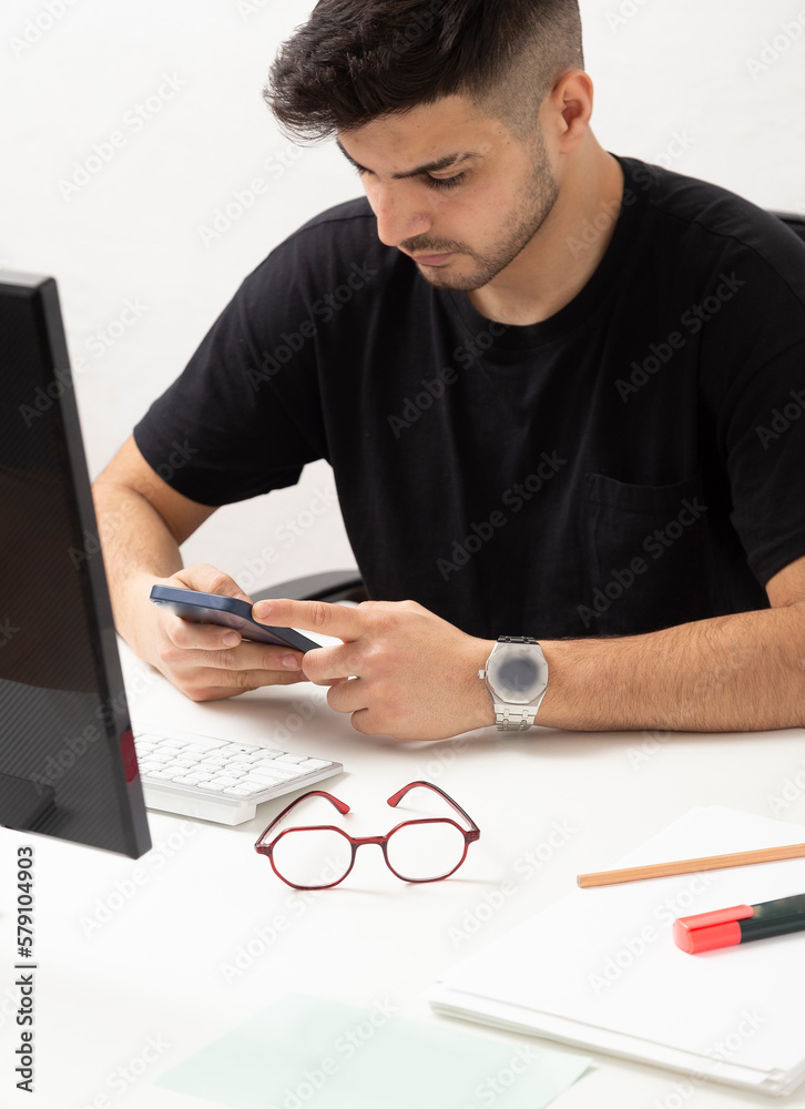 Young man working and typing message in his home office.education.business.e-commerce Young man working and typing message in his home office.education.business.e-commerce