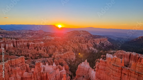 Aerial sunrise view of impressive hoodoo sandstone rock formations in Bryce Canyon National Park  Utah  USA. First morning sun rays touching on natural unique amphitheatre sculpted from red rocks