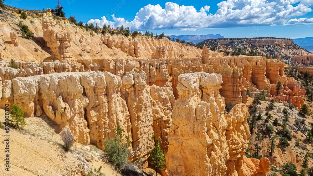 Fototapeta premium Scenic aerial view of Boat Mesa and massive hoodoo wall sandstone rock formation on Fairyland hiking trail in Bryce Canyon National Park, Utah, USA. Unique nature in barren landscape. Clouds emerging