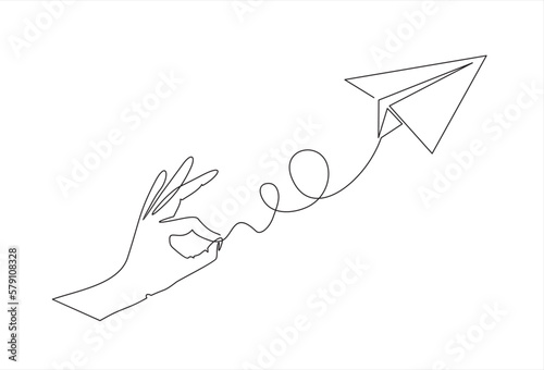 Hand launches into the sky airplane isolated on white background. continuous line illustration. one line vector. concept of traveling
