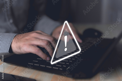 Computer hack warning,System hacked warning alert on notebook (Laptop),cyber security concept,The danger of malware viruses,ransomware virus,triangle caution warning sign notification error