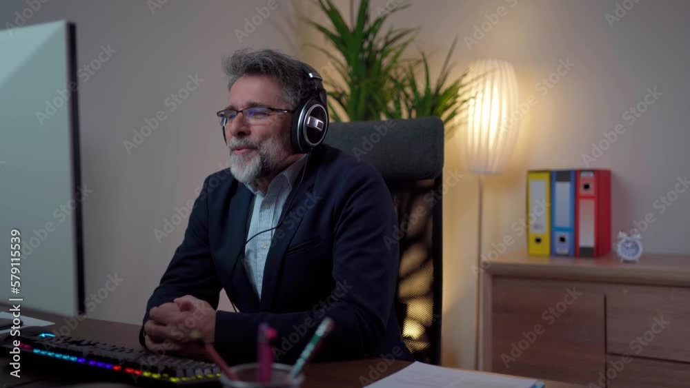 man in glasses wearing headphones holding video call with clients partners. consulting online on helpline. talk with clients provide information strategizing remotely man in glasses wearing headphones holding video call with clients partners. consulting online on helpline. talk with clients provide information strategizing remotely