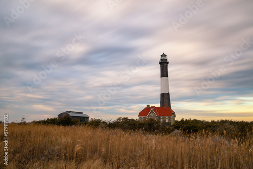 Streaky colorful sunset clouds behind a stone lighthouse Fire Island  Long Island New York