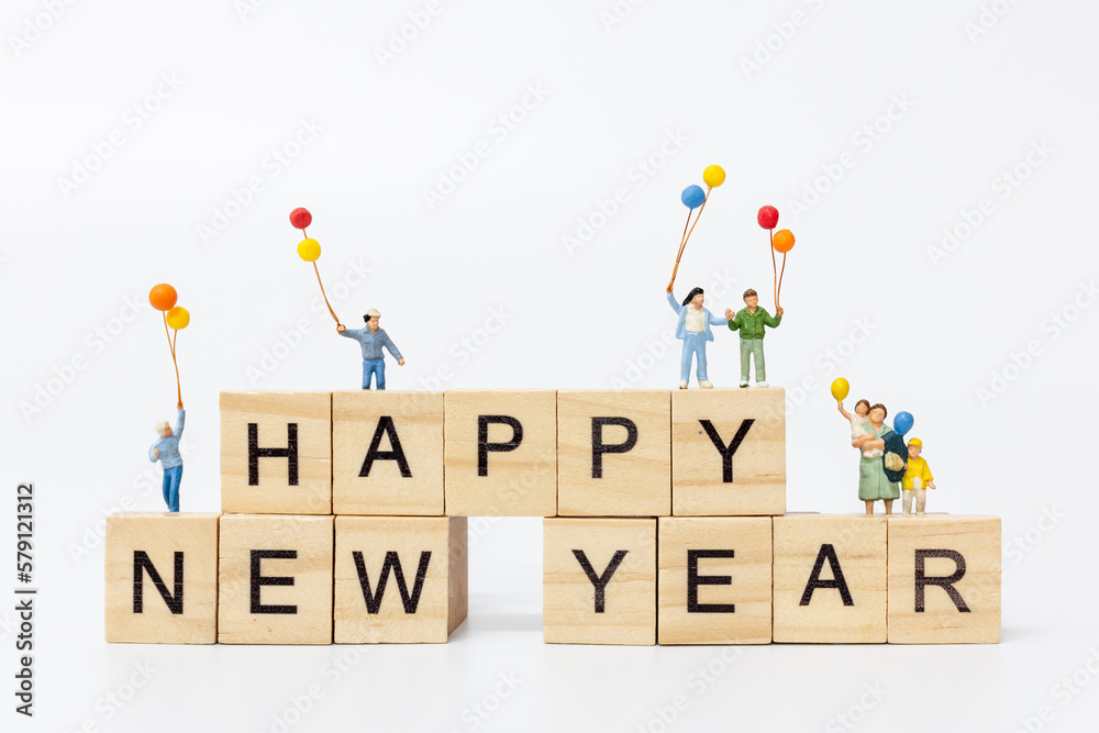 Miniature people : Happy family standing on wooden block Happy new year