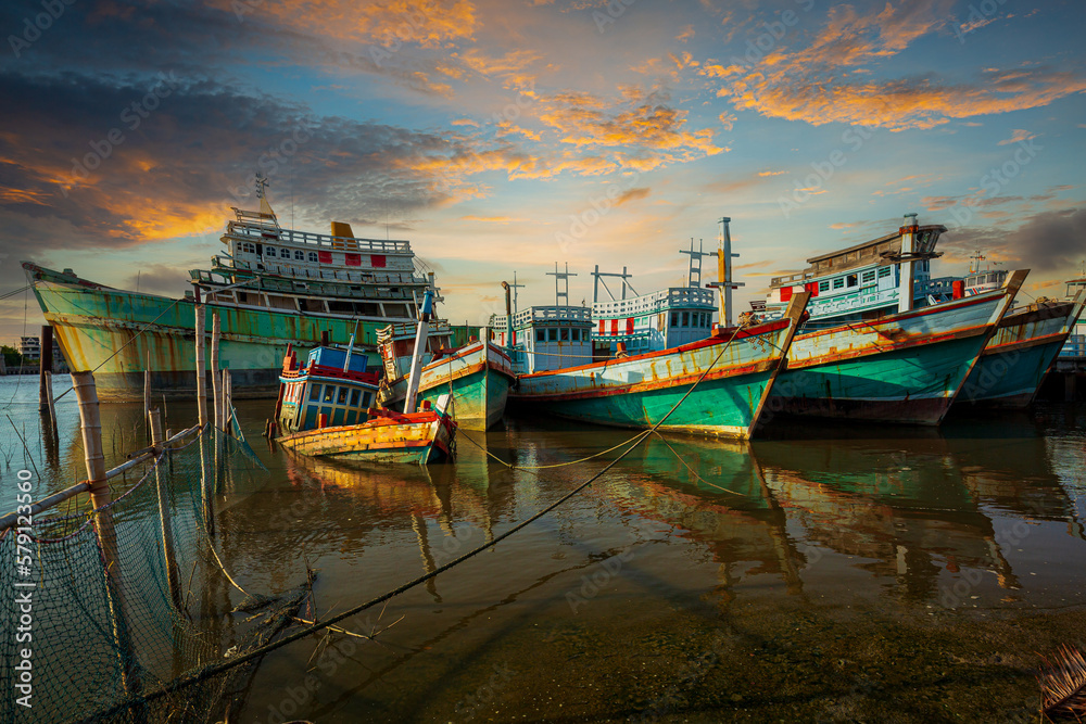 Many boats moored in sunrise morning time at Chalong port, Main port for travel ship to krabi and phi phi island, Phuket, Thailand 