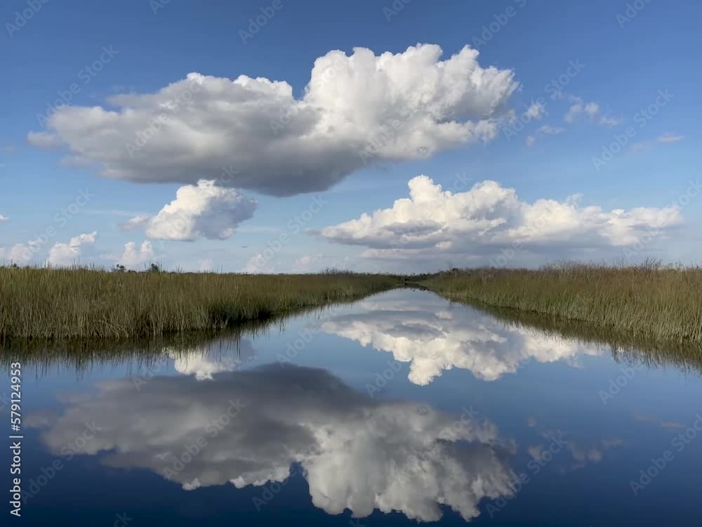 Gliding through the Florida Everglades with the sky reflecting in the wetlands Gliding through the Florida Everglades with the sky reflecting in the wetlands