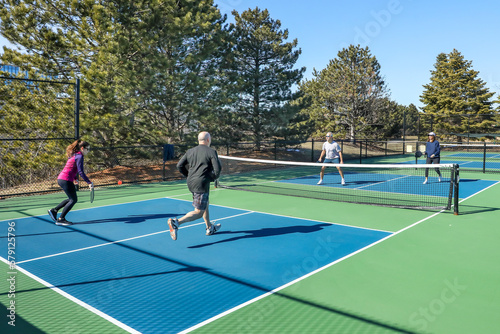 Men and Women in a Doubles Game of Pickleball