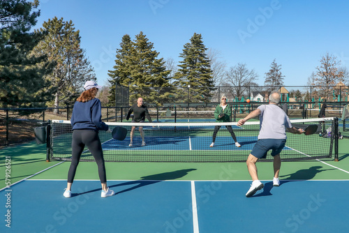 Men and Women at the Net in a Doubles Game of Pickleball