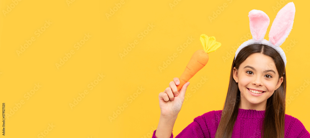 happy easter teen girl in funny bunny ears hold carrot. Easter child horizontal poster. Web banner header of bunny kid, copy space. happy easter teen girl in funny bunny ears hold carrot. Easter child horizontal poster. Web banner header of bunny kid, copy space.
