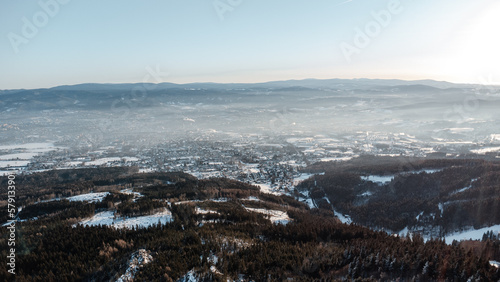 A bird's eye view of snowy Liberec at sunrise. Photographed on Jested Ridge by drone in winter.