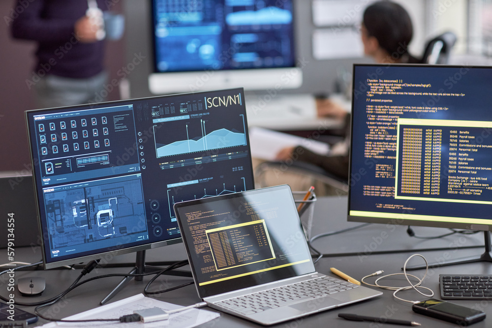 Background image of multiple computer screens with data and code on ...