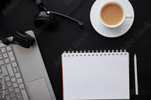 Traditional office lifestyle - mock up notebook with pen  laptop  cup of coffee and headphones. Freelance concept  working remotely  taking webinar  listening music  studying flat lay
