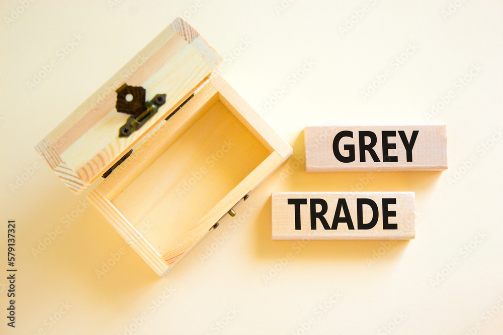Grey trade symbol. Concept words Grey trade on wooden block. Beautiful white table white background. Empthy opened wooden chest. Business grey trade concept. Copy space. Grey trade symbol. Concept words Grey trade on wooden block. Beautiful white table white background. Empthy opened wooden chest. Business grey trade concept. Copy space.