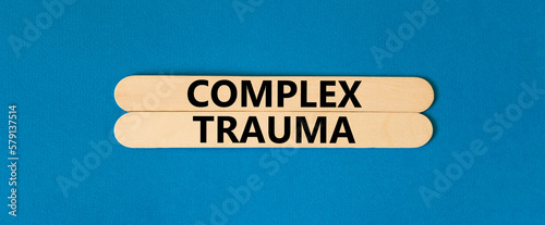 Complex trauma symbol. Concept words Complex trauma on wooden sticks. Beautiful blue table blue background. Business psychology complex trauma concept. Copy space.