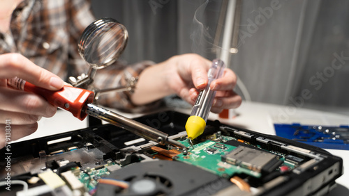 computer repairman soldering chip soldering iron