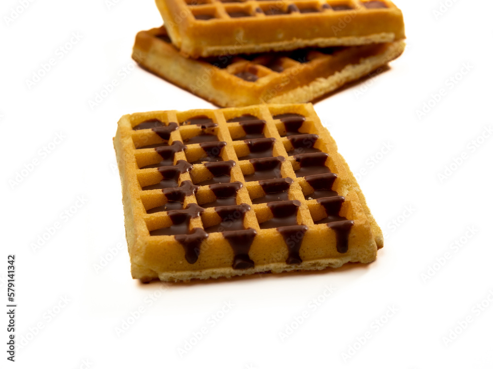 Chocolate waffles isolated on white background. Waffles in chocolate. Close-up. Chocolate waffles isolated on white background. Waffles in chocolate. Close-up.