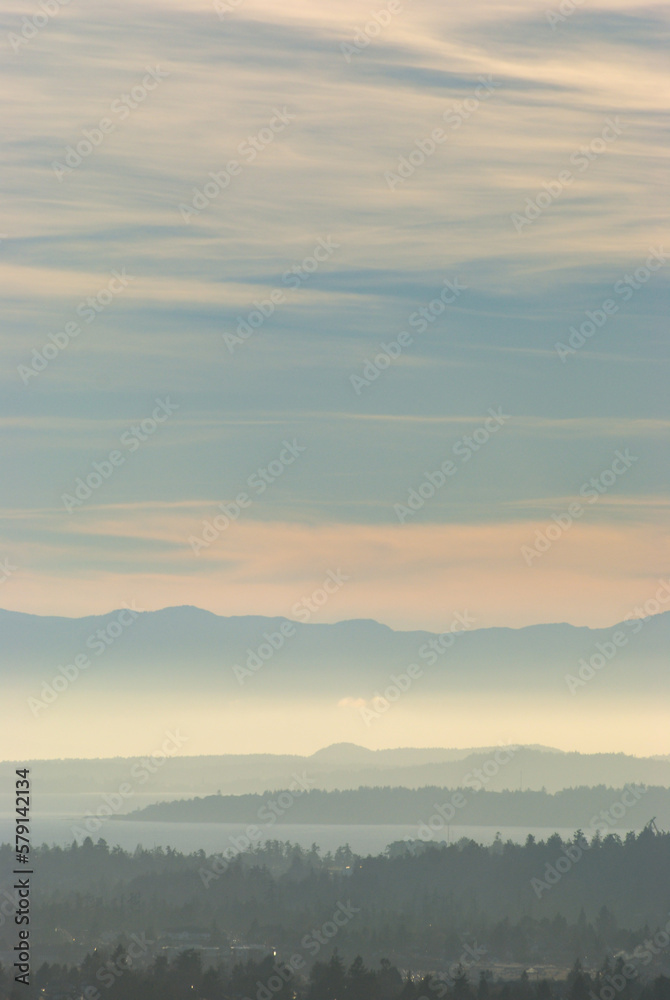 Stunning colors over the south of Vancouver Island as the sun sets through a hazy sky. Stunning colors over the south of Vancouver Island as the sun sets through a hazy sky.