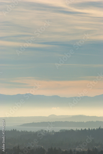 Stunning colors over the south of Vancouver Island as the sun sets through a hazy sky.