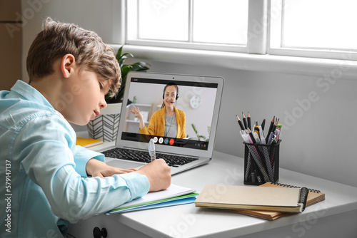 Cute little boy studying on...