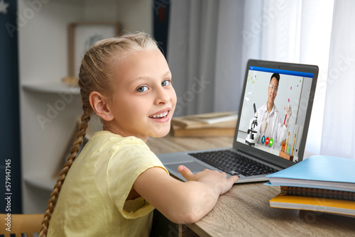 Cute little girl studying o...