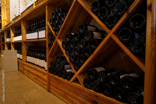 Wooden storage stand with bottles of wine in store