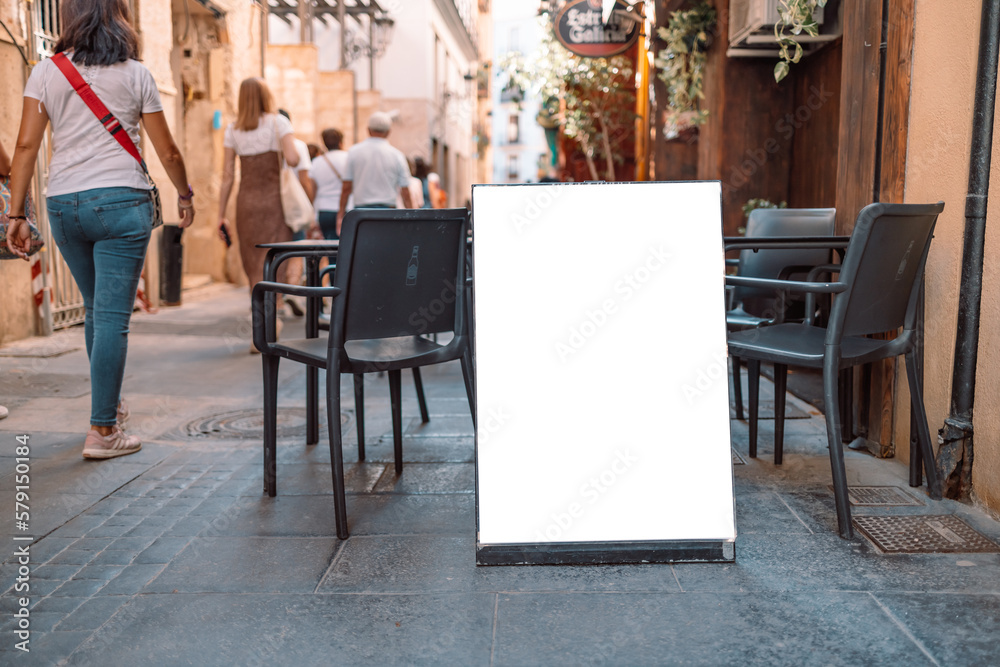 Close up of empty white poster near cafe or restaurant. Mockup background. Close up of empty white poster near cafe or restaurant. Mockup background.