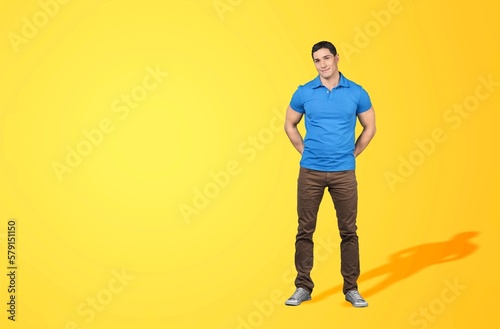 Happy young smart man posing on background