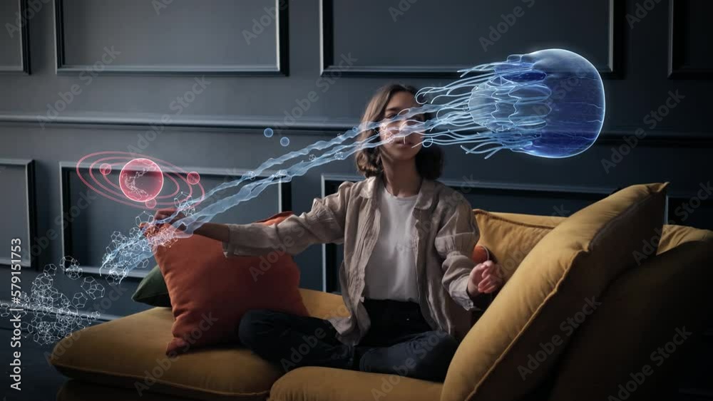 A cute teenage girl discovers an amazing space world. Virtual planets, stars and a huge futuristic jellyfish fly through the air around the delighted child.