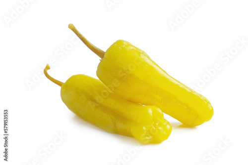 Two pickled yellow peppers, pepperoncini or friggitelli isolated on white background. Hot pepper marinated, brined. Traditional Italian and greek cuisine, ingredient for salad, pasta, sauce.