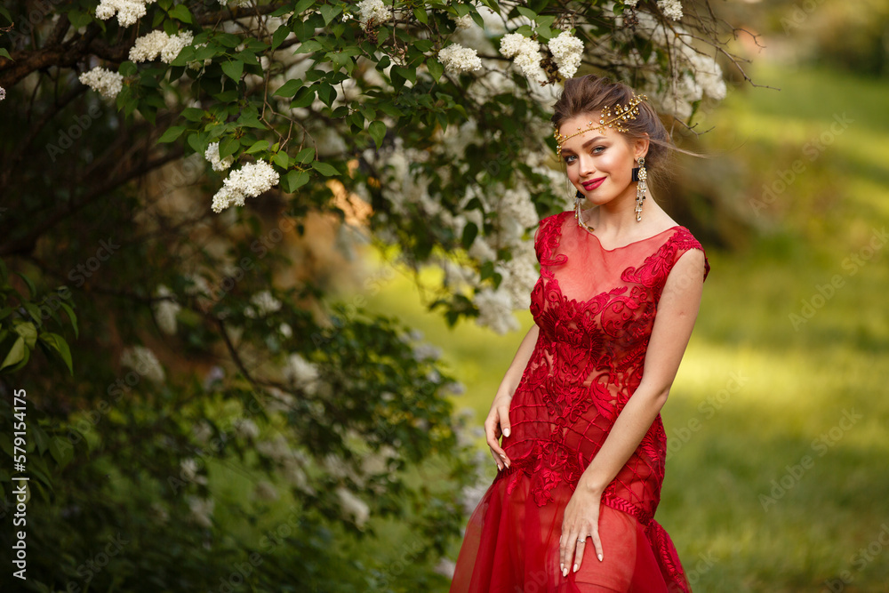 Beautiful woman in blooming lilac garden. Half-body Portrait in sunset light. Pretty young caucasian girl in beauty princess character. Romantic spring mood. Spring dreamy lady. Make up and hairstyle Beautiful woman in blooming lilac garden. Half-body Portrait in sunset light. Pretty young caucasian girl in beauty princess character. Romantic spring mood. Spring dreamy lady. Make up and hairstyle