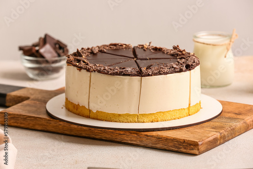 Canvas Print Wooden board with tasty birds milk cake on light table, closeup