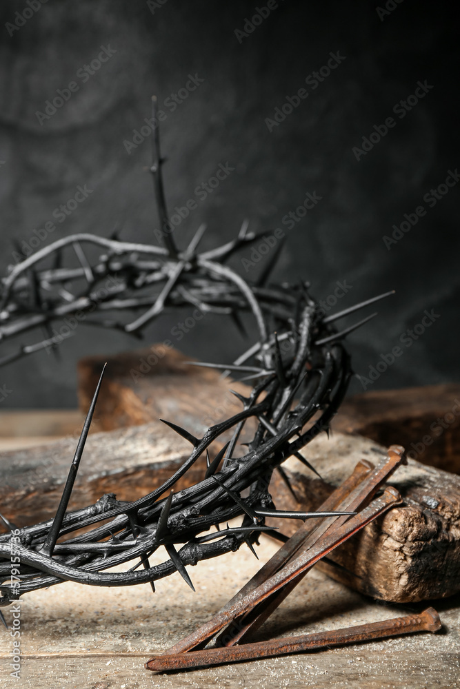 Crown of thorns, nails and cross on wooden table, closeup Crown of thorns, nails and cross on wooden table, closeup