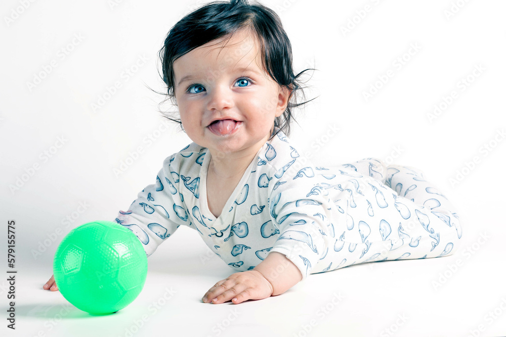 Baby with green eyes playing with a ball Baby with green eyes playing with a ball