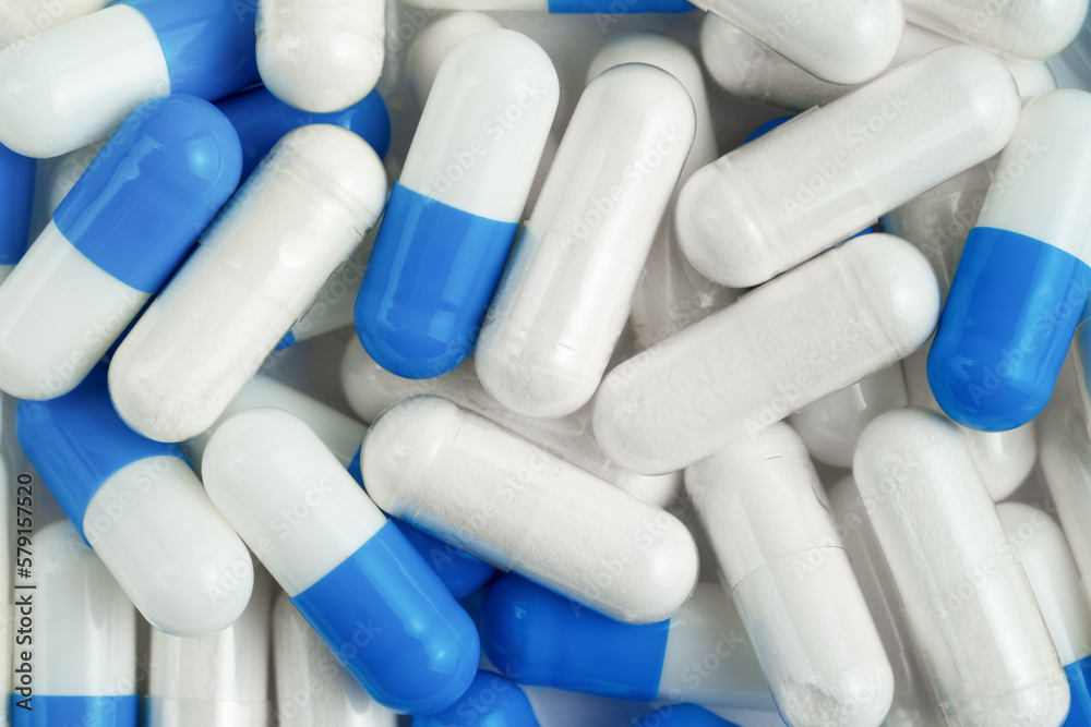 White and blue capsules background. Top view White and blue capsules background. Top view