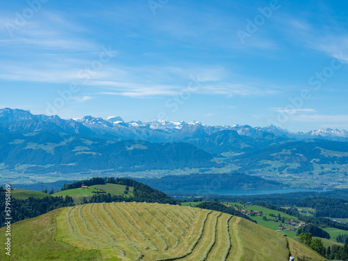 Zurich, Switzerland - June 12th 2022: Amazing view from Alp Scheidegg over hills and the lake towards the mountains