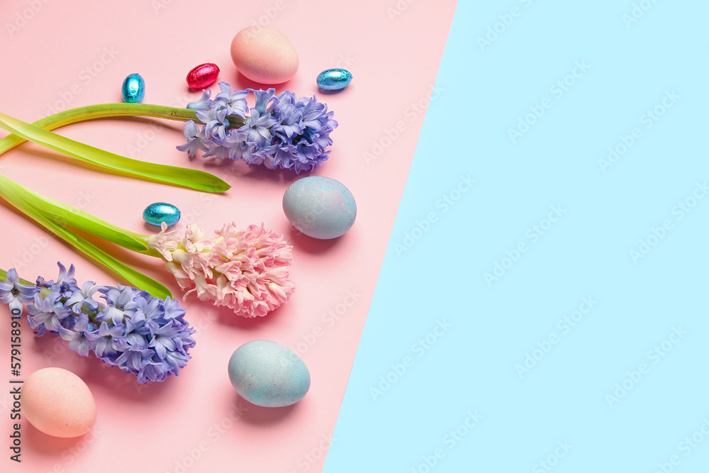 Beautiful hyacinth flowers and Easter eggs on colorful background