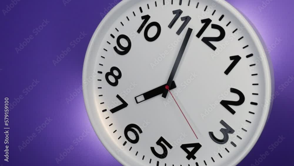 A White Wall Clock On Purple Background With A Time Of 7.00 Am Or Pm. A Black Hands and Red Second Hand Of The Clock. Timelapse. 4k. ProRes. A White Wall Clock On Purple Background With A Time Of 7.00 Am Or Pm. A Black Hands and Red Second Hand Of The Clock. Timelapse. 4k. ProRes.