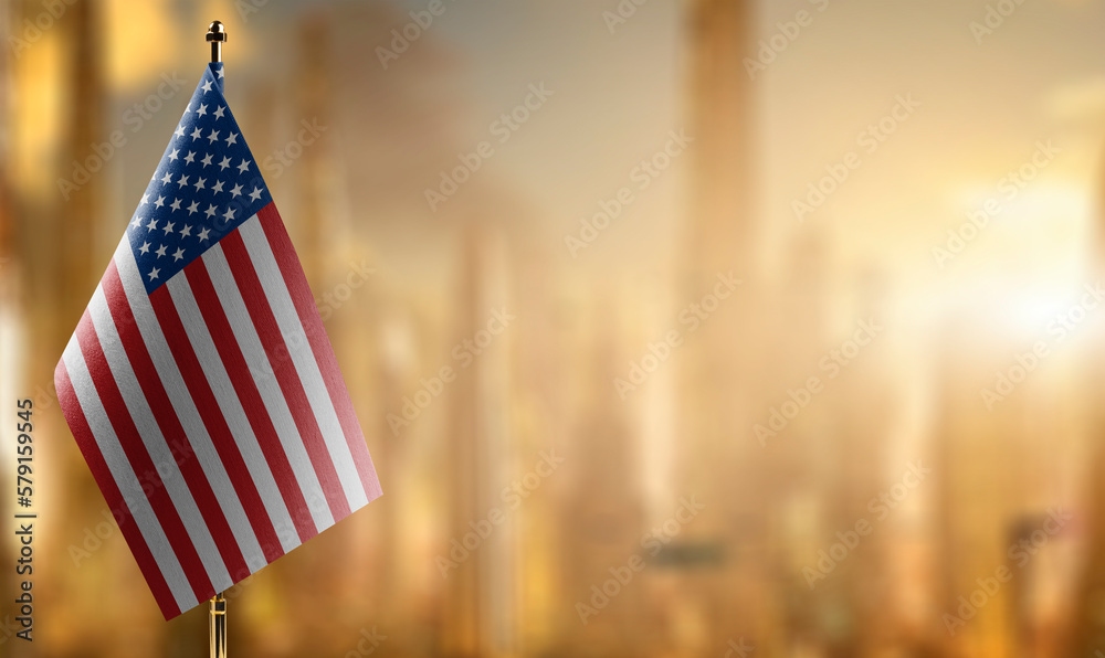 Small flags of the USA on an abstract blurry background - obrazy, fototapety, plakaty 