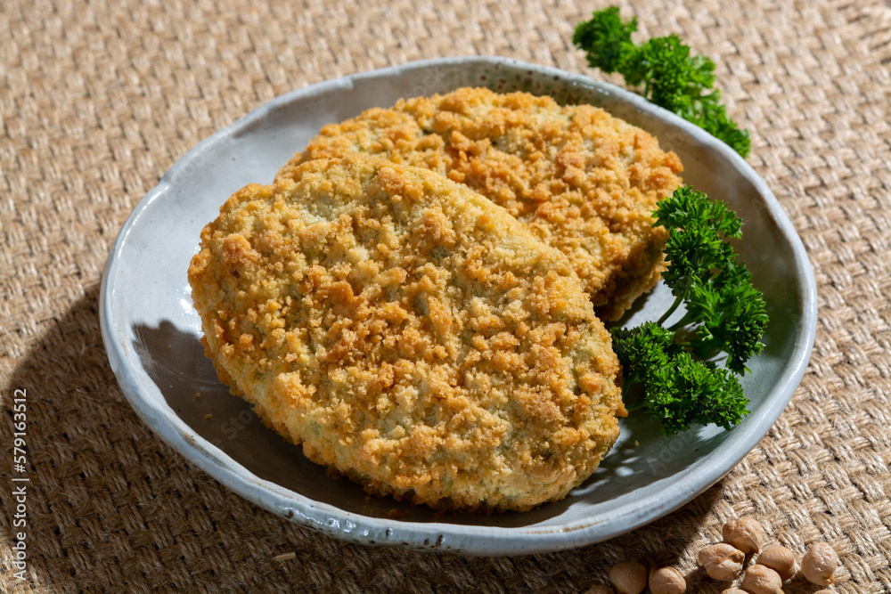 Uncooked fresh vegan and vegetarian burgers made from fresh vegetables and dried legumes and beans, ready to barbecue grill Uncooked fresh vegan and vegetarian burgers made from fresh vegetables and dried legumes and beans, ready to barbecue grill