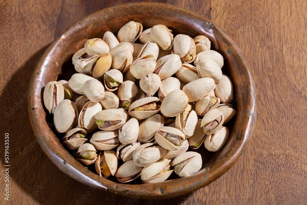 Roasted salty pistachio nuts, tasty healthy vegetarian food Roasted salty pistachio nuts, tasty healthy vegetarian food