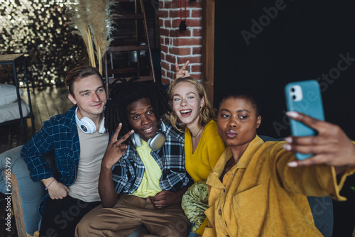 Cheerful group of diverse best friends taking selfie. Young people internation students have fun together, party, celebrate. African American, Caucasian multi cultural college university community photo