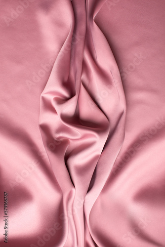 Pink soft fabric shaped as female genital organs, vulva and labia, vagina concept