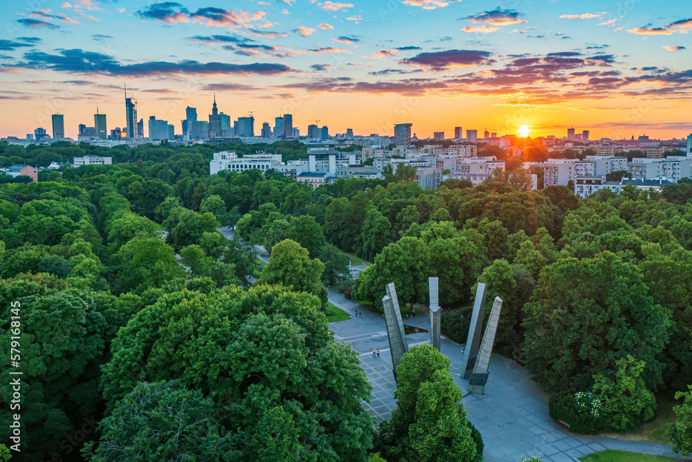 Sunset over green park and Warsaw city center, aerial landscape