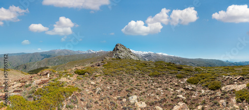 Summer mountain landscape with snow on ridge (Sierra Nevada National Park, near Granada, Spain). Panorama.