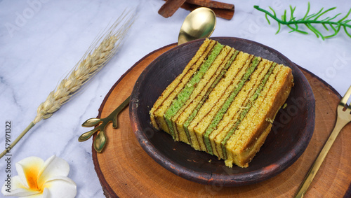 Traditional Indonesian sweet Lapis layer cake on wooden plate. Indonesian layered cake called 