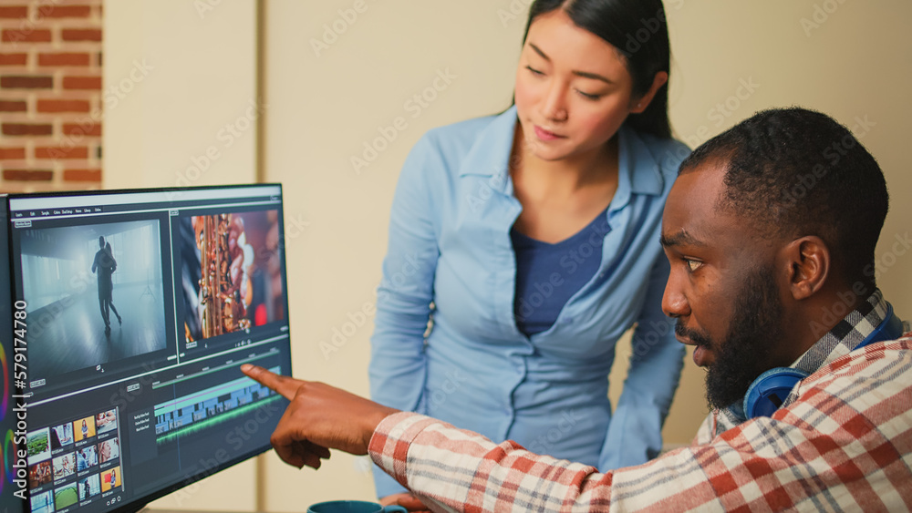 Creative filmmakers doing teamwork to edit video footage, using videography software in agency studio. Diverse colleagues working on film montage editing as graphic designers or artists. - obrazy, fototapety, plakaty 